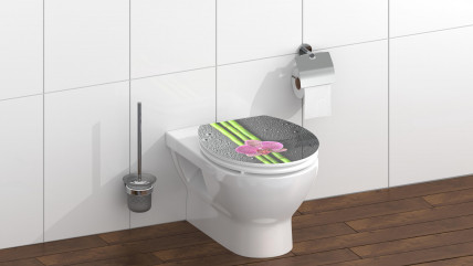 Toilettensitz mit Bambusmotiv und pinker Orchidee vor Verpackung mit Herstellerlogo.